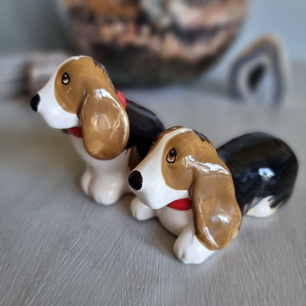 Pair of vintage ceramic beagle salt and pepper shakers with red collars.