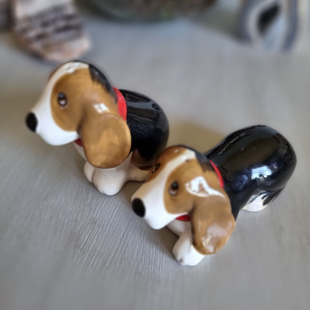 Pair of vintage ceramic beagle salt and pepper shakers with red collars.