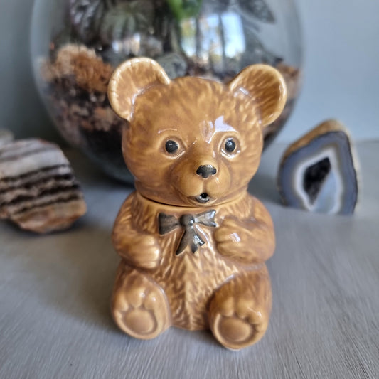 Vintage ceramic bear honey pot with bowtie and removable head for storing honey.