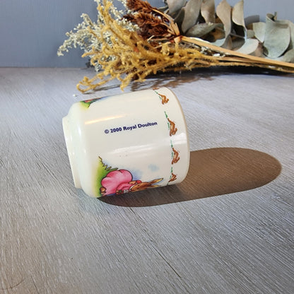 Royal Doulton Bunnykins egg cup with rabbit countryside scene.