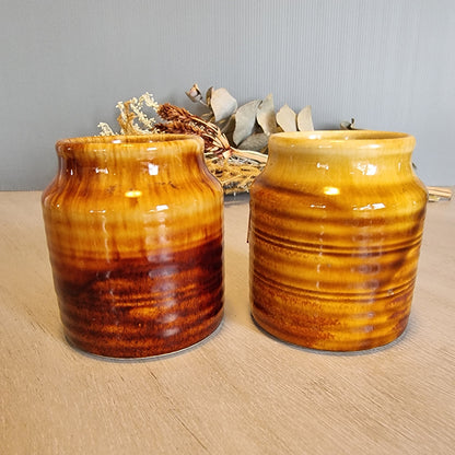 Pair of Crown Lynn drip glaze jars in golden brown tones.