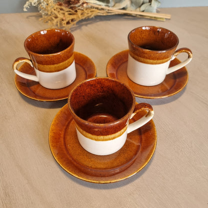 Crown Lynn Pioneer cups and saucers in brown and cream glaze, set of three.