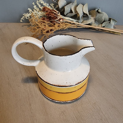 Stonehenge Midwinter Sun pitcher with yellow and ochre bands, made in England.