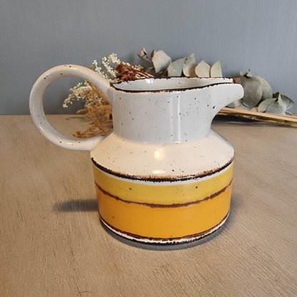 Stonehenge Midwinter Sun pitcher with yellow and ochre bands, made in England.