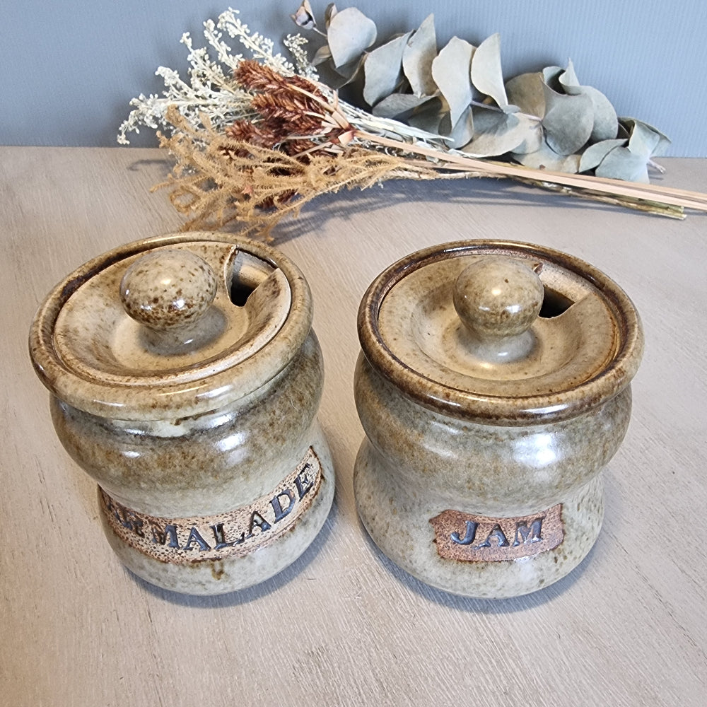 Pair of vintage stoneware jam and marmalade pots with rustic glaze and embossed lettering.