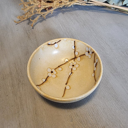 Japanese Kotobuki ceramic bowl with white blossom and branch design.