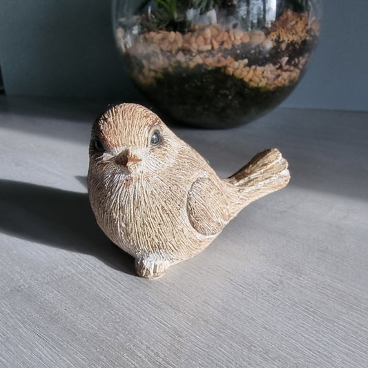 Rustic ceramic bird ornament with natural wood-tone finish.