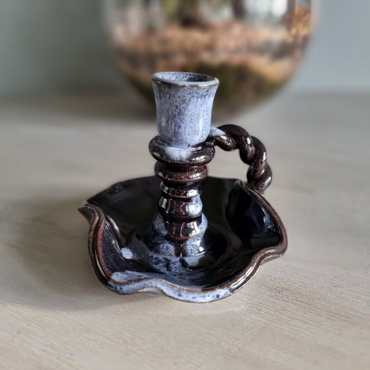 Vintage ceramic candlestick with brown-blue glaze and twisted handle.