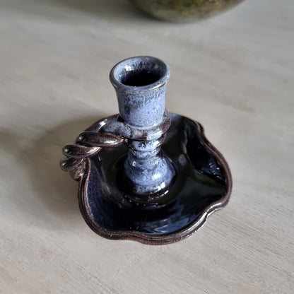 Vintage ceramic candlestick with brown-blue glaze and twisted handle.