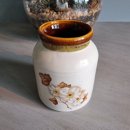 Kermiko Potteries floral ceramic jar with brown rim and blossom design.