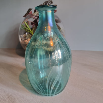 Hand-blown teal art glass vase with iridescent finish and feather swirl design.