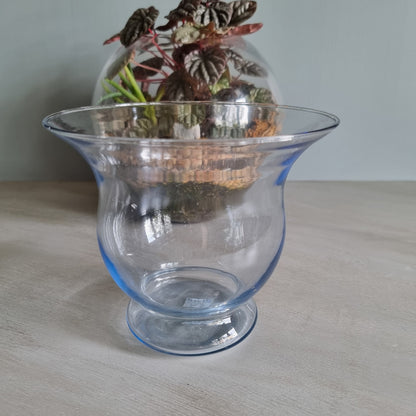 Vintage blue glass vase with flared rim and soft blue tint.
