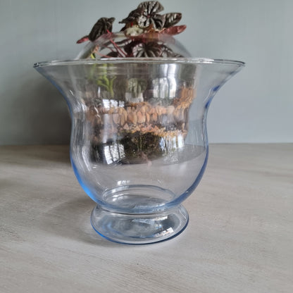 Vintage blue glass vase with flared rim and soft blue tint.