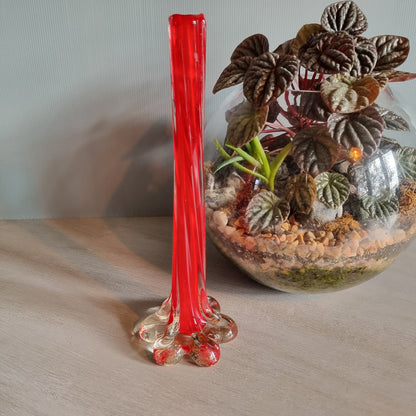 Vintage red art glass bud vase with clear base and pulled-stem design.