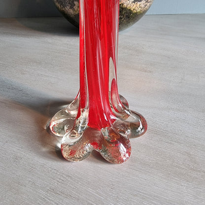 Vintage red art glass bud vase with clear base and pulled-stem design.