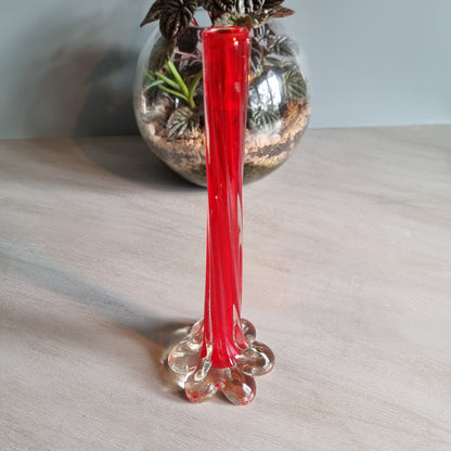 Vintage red art glass bud vase with clear base and pulled-stem design.