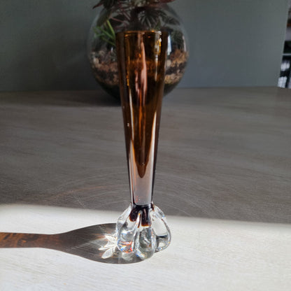 Vintage amber art glass bud vase with clear pulled base and warm retro glow.