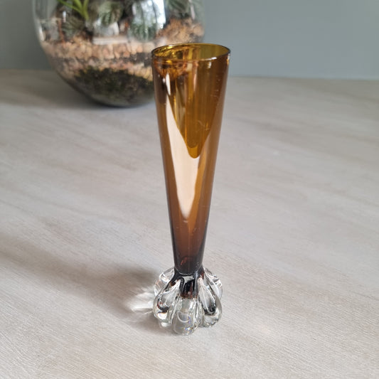 Vintage amber art glass bud vase with clear pulled base and warm retro glow.