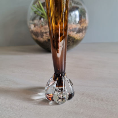 Vintage amber art glass bud vase with clear pulled base and warm retro glow.