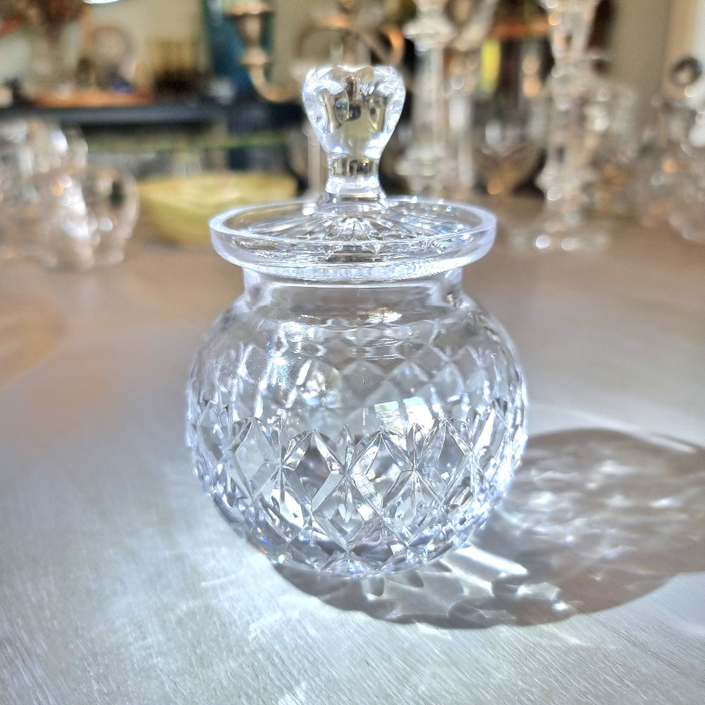 Pressed glass jam jar with faceted lid handle and diamond-cut pattern.