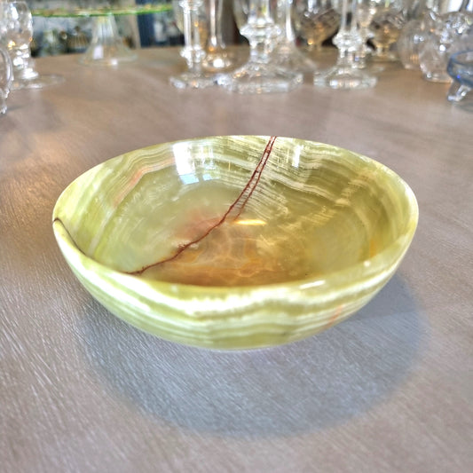 Green onyx dish with natural veining and soft layered tones.