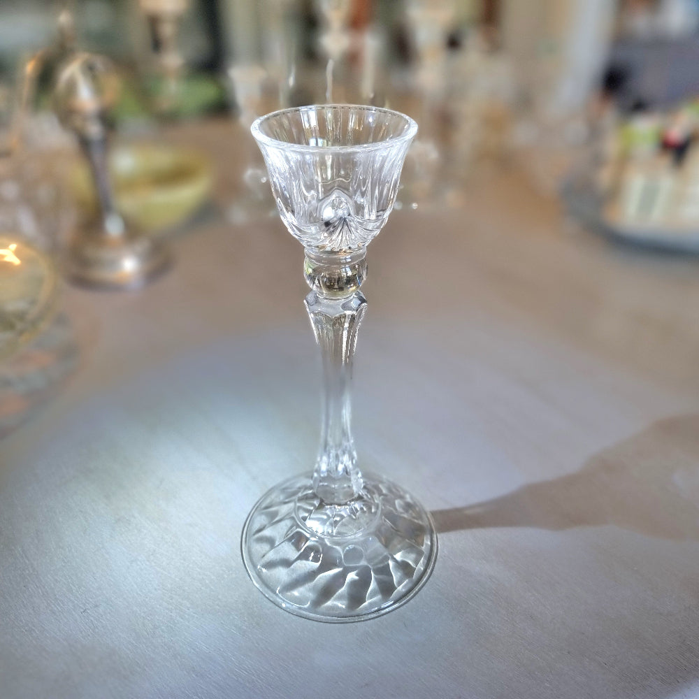 Tall crystal candle holder with fluted cup and textured base.