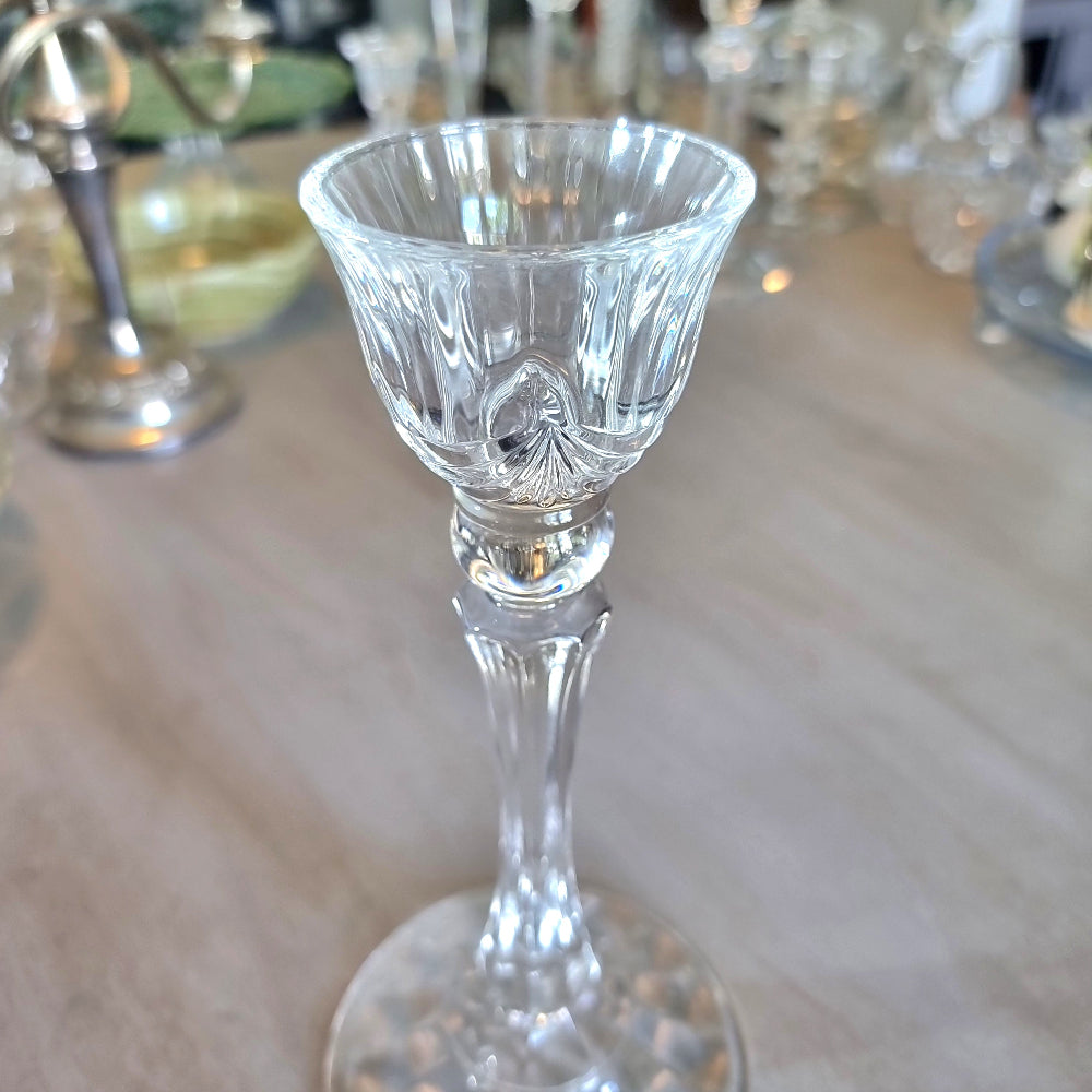 Tall crystal candle holder with fluted cup and textured base.