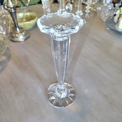 Tall slender crystal candle holder with faceted top and starburst base.