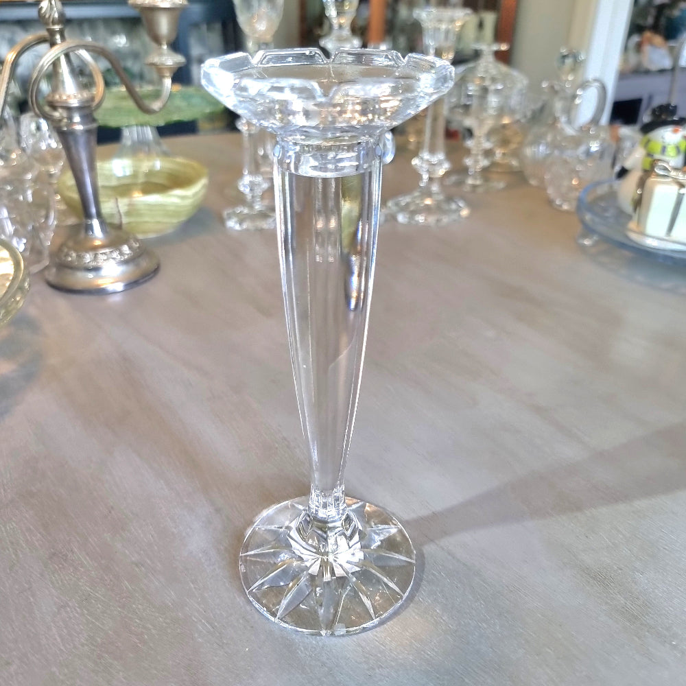 Tall slender crystal candle holder with faceted top and starburst base.