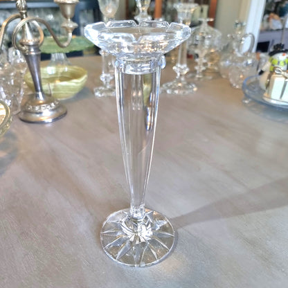Tall slender crystal candle holder with faceted top and starburst base.