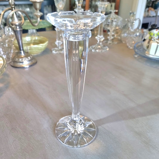Tall slender crystal candle holder with faceted top and starburst base.