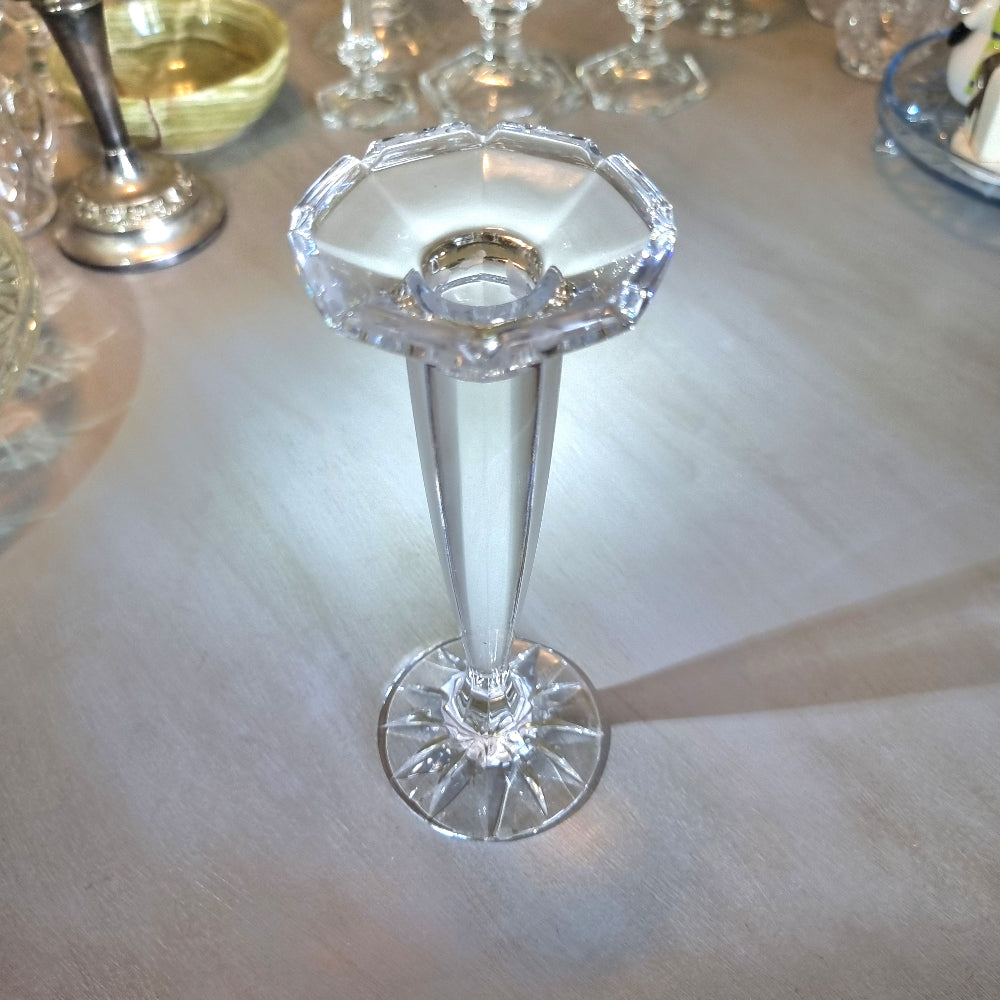 Tall slender crystal candle holder with faceted top and starburst base.