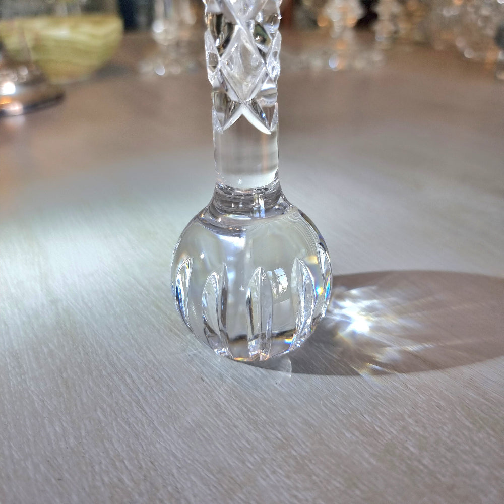 Crystal bud vase with lattice-cut stem and rounded faceted base.