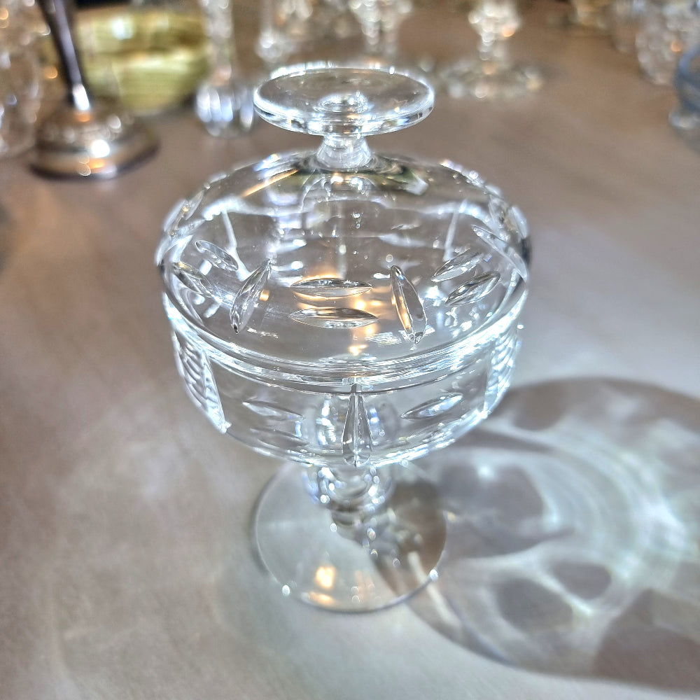 Cut crystal lidded compote with oval cut-outs and pedestal base.