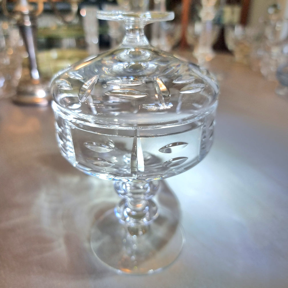 Cut crystal lidded compote with oval cut-outs and pedestal base.
