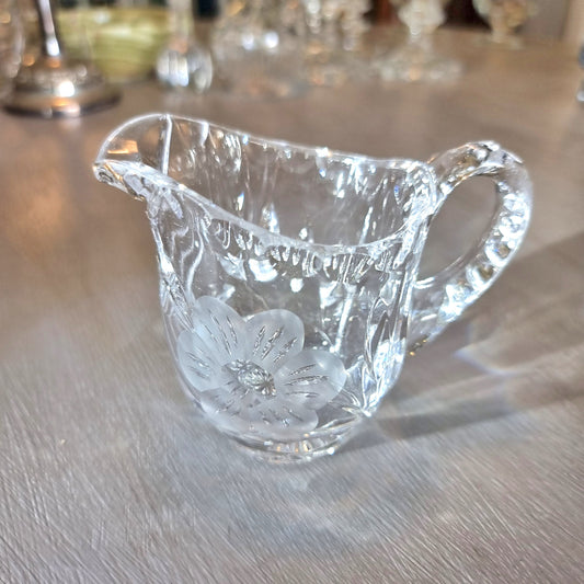 Etched crystal cream jug with frosted flower motif and cut-glass detailing.