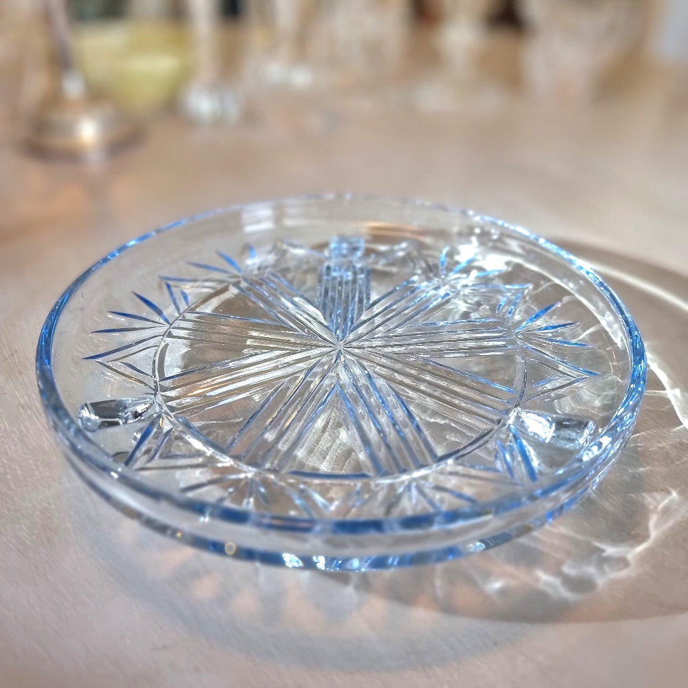 Art Deco pressed glass plate with geometric starburst pattern.