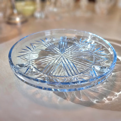 Art Deco pressed glass plate with geometric starburst pattern.