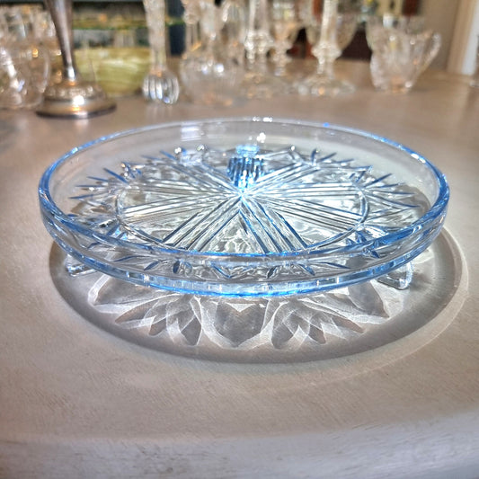 Art Deco pressed glass plate with geometric starburst pattern.