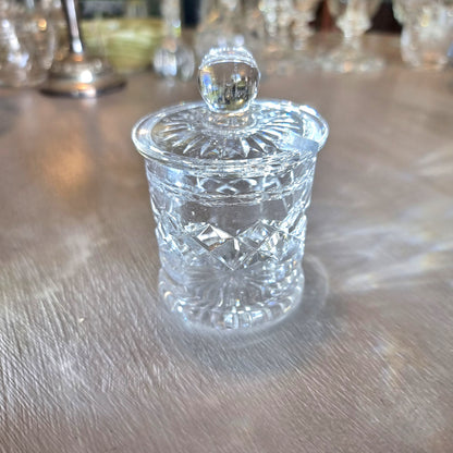 Small crystal jam jar with starburst lid and faceted cut-glass pattern.