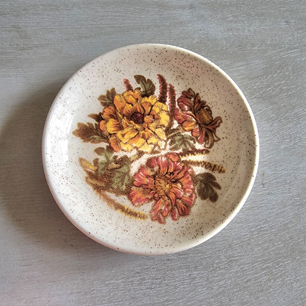 Vintage Palissy England dish with yellow and orange floral design and speckled glaze.