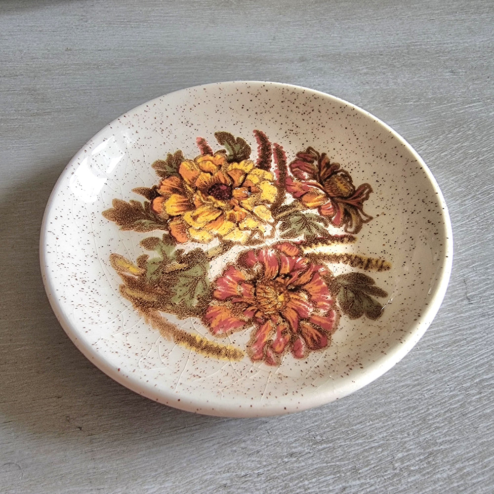 Vintage Palissy England dish with yellow and orange floral design and speckled glaze.