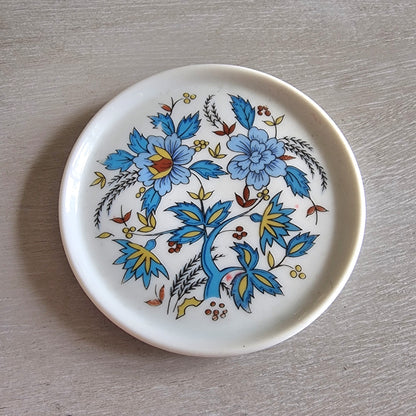 Vintage Porcelana Schmidt Brasil plate with bright blue and yellow floral design.