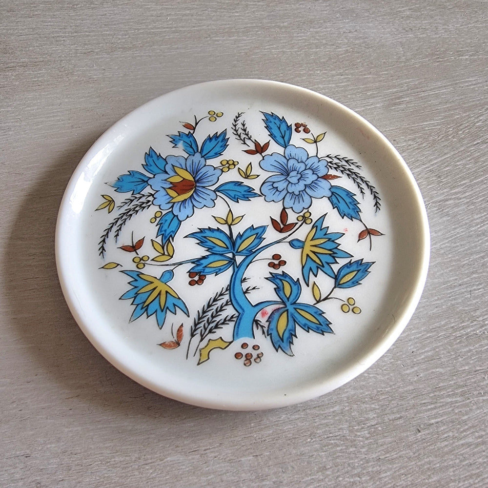 Vintage Porcelana Schmidt Brasil plate with bright blue and yellow floral design.