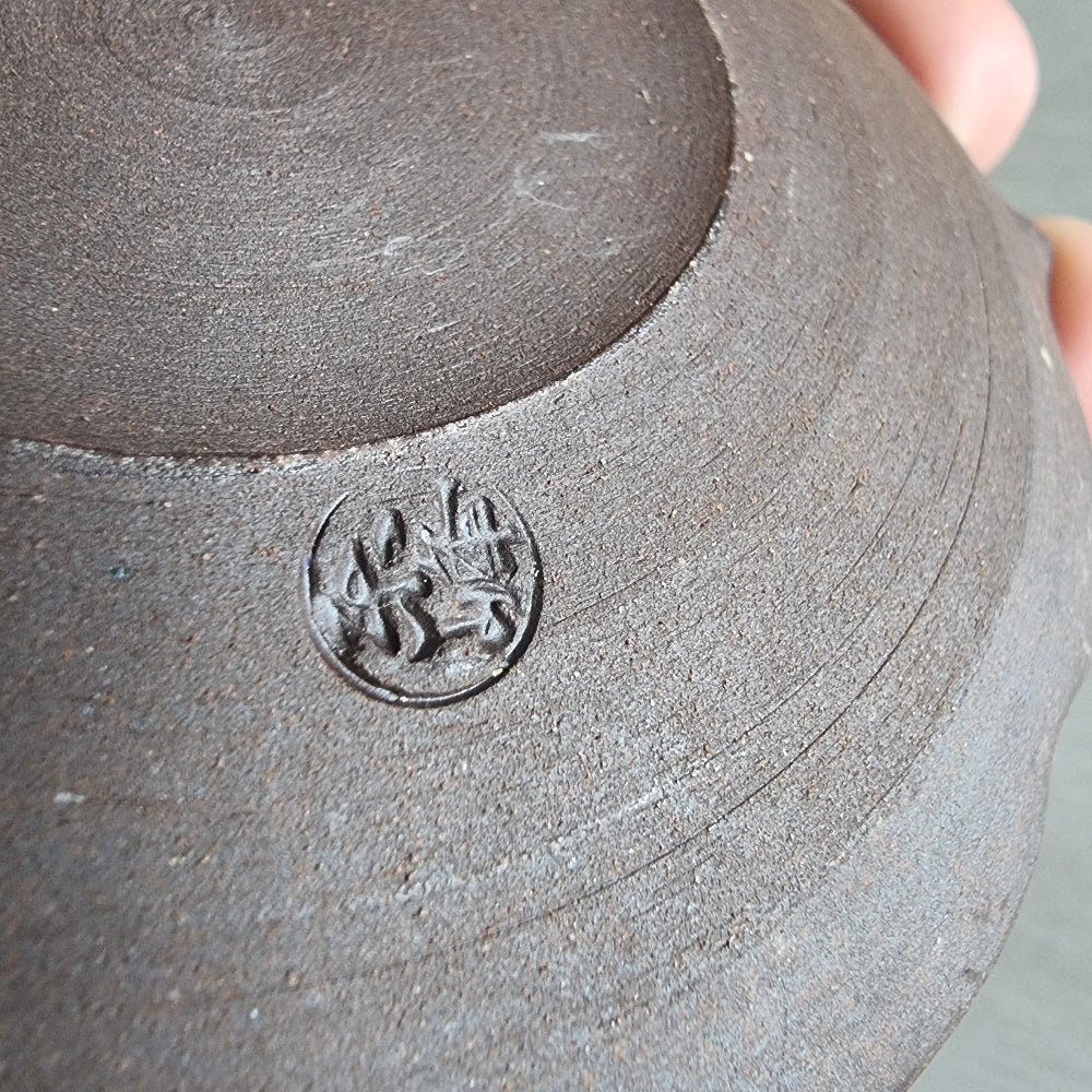 Pair of ceramic dishes with blue floral centres and speckled mauve scalloped rims.