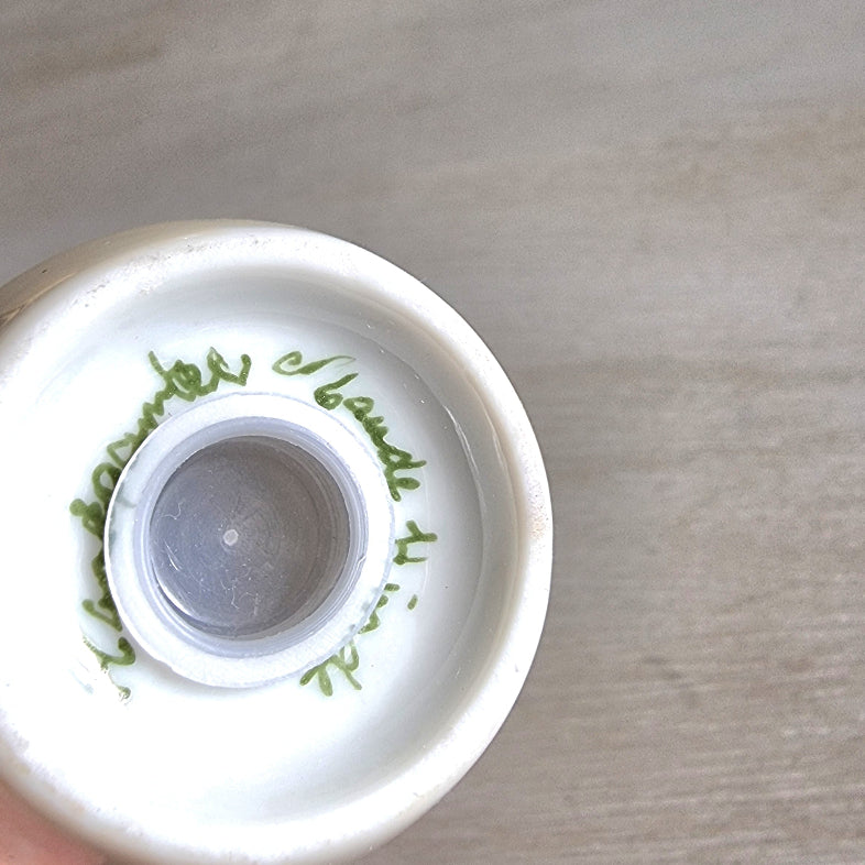 Hand-painted floral salt and pepper shakers with yellow flowers by Maude Hinde.