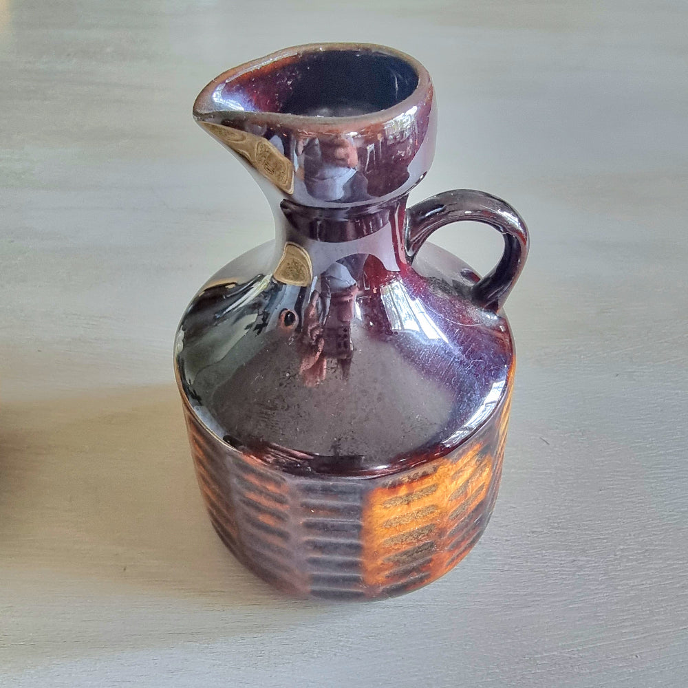 Vintage Crown Lynn brown glazed jug with textured amber-toned base.