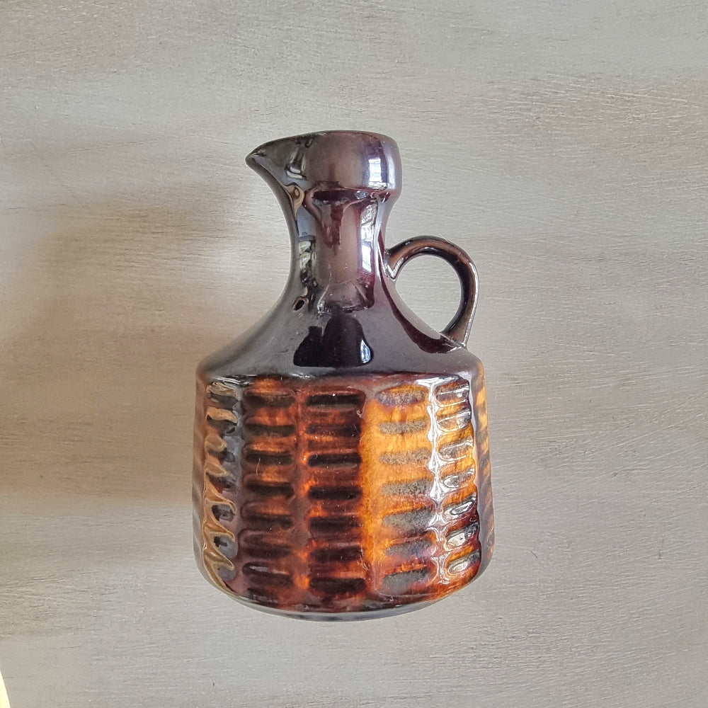 Vintage Crown Lynn brown glazed jug with textured amber-toned base.