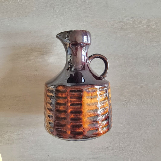 Vintage Crown Lynn brown glazed jug with textured amber-toned base.