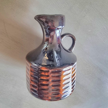 Vintage Crown Lynn brown glazed jug with textured amber-toned base.